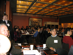 Participants listen intently in the packed room